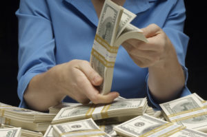 woman counting hundreds of dollars how to make extra money
